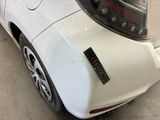 a close up of a white car with a sticker on it