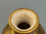a vase that has a gold and blue design on it