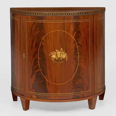 a close up of a wooden cabinet with a gold decoration