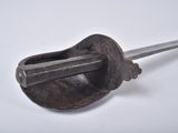 a metal object with a handle on a white surface