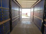 a long hallway leading to a building with blue walls