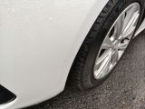 a close up of a car ' s tire on a wet road