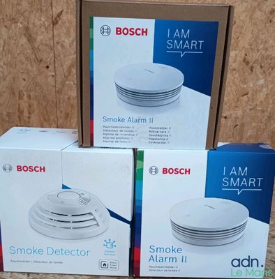 three boxes of bosch smoke detector sitting on top of a table