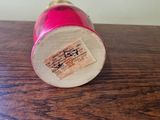 a small pink object sitting on a wooden table