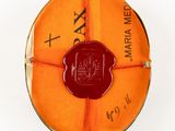 an orange wax seal on top of a red wax seal