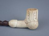 a pipe that is sitting on a table next to a wall