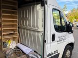a white van with a large open door in a parking lot