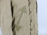 an image of a man in a khaki jacket with a hat on his head