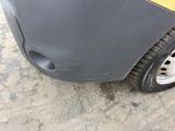 a close up of a car ' s front bumper and tire
