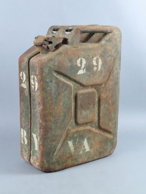 an old metal canister sitting on top of a white surface