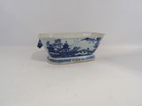 a small blue and white bowl with a bird on it
