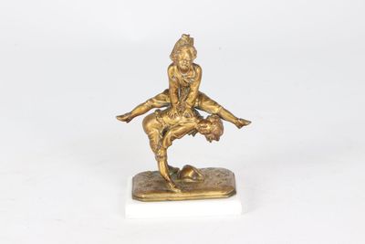 bronze figurine of a man on a skateboard on a marble base