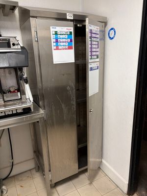 a stainless steel refrigerator in the corner of a kitchen