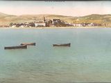 many boats that are in the water near the shore