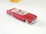 a red toy car sitting on a white surface
