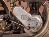 a close up view of a motorcycle engine with a red brick wall in the background