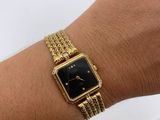 an image of a woman wearing a gold watch on her wrist