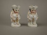 pair of white porcelain figurines of a man and a woman