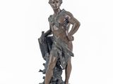 bronze statue of a woman with an umbrella on a rock