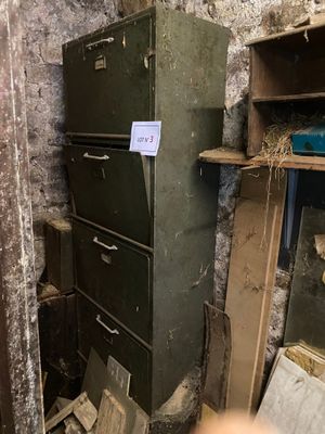 a refrigerator in the corner of a room with a sign on it