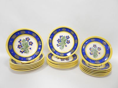 a set of six blue and yellow plates with flowers on them