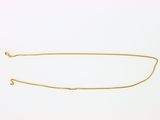 une image d'un collier en or sur fond blanc