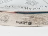 a close up of a silver coin on a white surface
