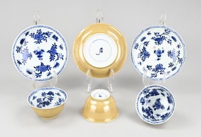 a group of blue and white plates and bowls on a table