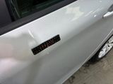 a close up of a car door with a sticker on it