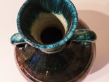 a blue and green cup and saucer on a white table