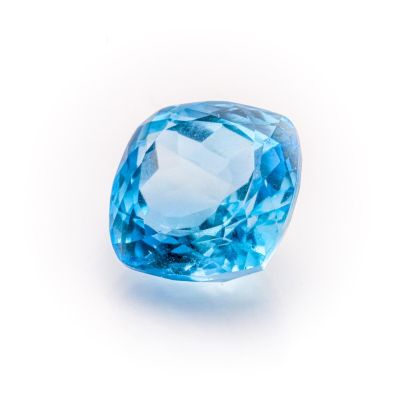 a close up of a blue diamond on a white background