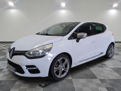 a white car is parked in a room with a checkered floor