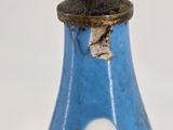 a blue vase with flowers on it sitting on a table