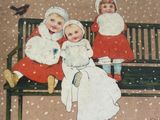 three children sitting on a bench in the snow