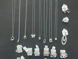 many different types of necklaces and bracelets displayed on a table