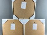 three pieces of cardboard sitting on top of each other on top of a table
