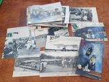 several old black and white photos of people and vehicles on a table