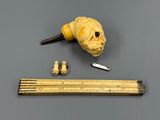 a yellow dog head and a ruler next to it