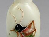a glass vase with a grasshopper painted on it