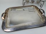 two silver trays sitting on a table next to each other
