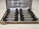 a metal case filled with chess pieces on a table