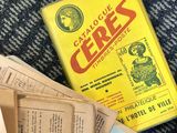 a pile of old books on the floor next to a box of cigarettes