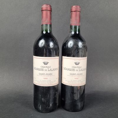 two bottles of red wine sitting next to each other on a table
