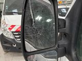 a broken mirror on the side of a white van