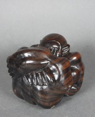 une image représentant une sculpture en bois d'un singe tenant un bébé dans ses bras