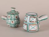 two teapots sitting next to each other on a table