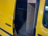 a yellow van with its door open in a garage