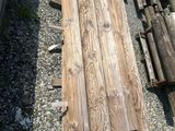 many pieces of wood sitting on the ground next to each other