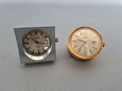 a silver and gold clock and a silver and gold watch