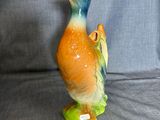 a figurine of a duck on a blue background